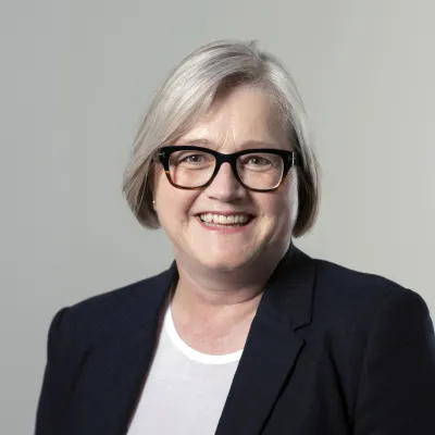 Woman with glasses and short grey hair