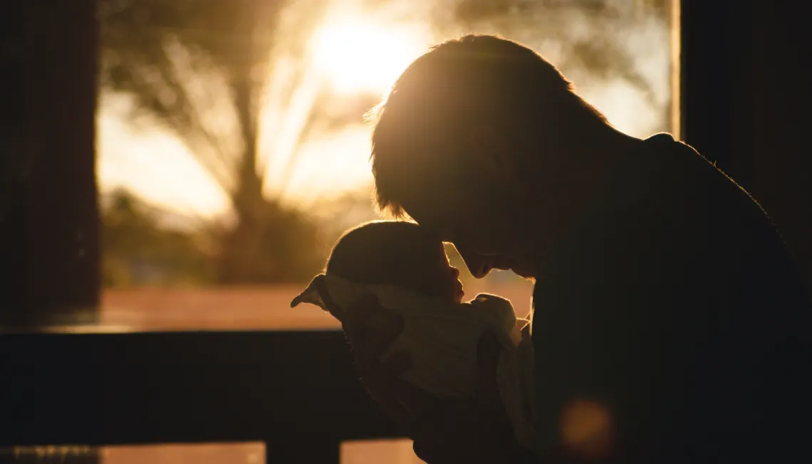 Silhouette of father and baby