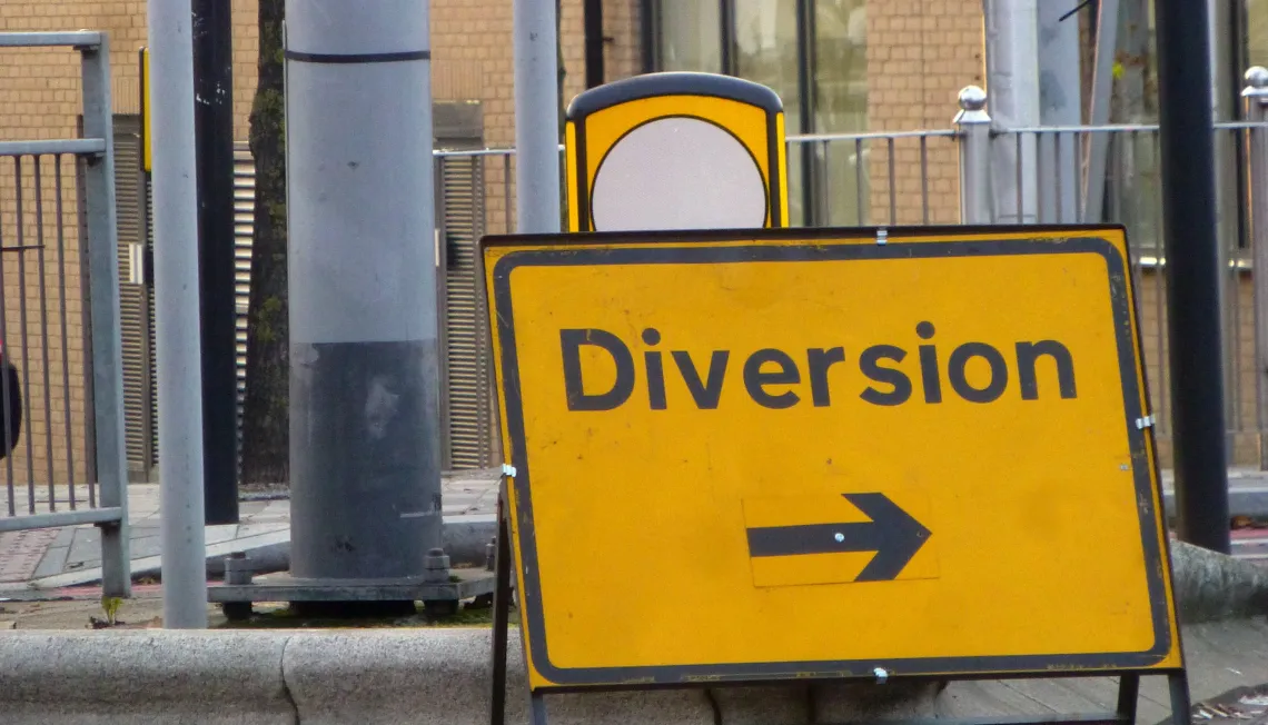 Photograph of a 'Diversion' road sign with an arrow