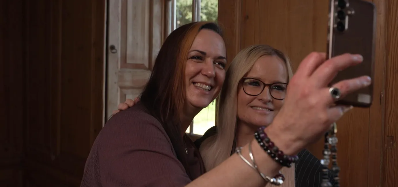 Two women smiling taking a selfie, in a still from Channel 4 News covering FDAC